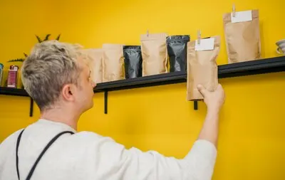 Side view of male barista in coffee shop
