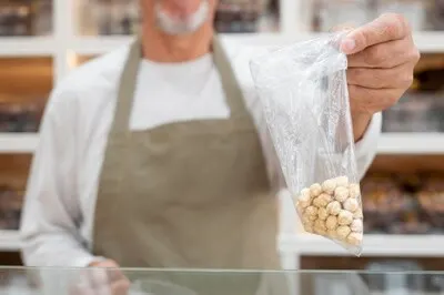 Producer at his shop with fresh foods