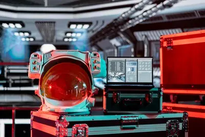 Red light in spacecraft over space helmet and laptop showing errors