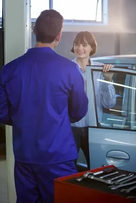 Smiling customer interaction with mechanic