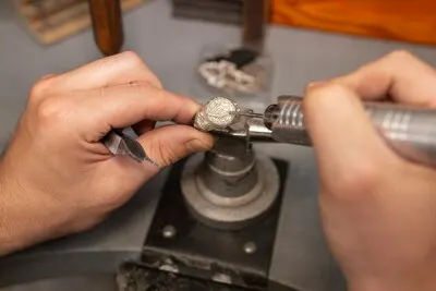 Jeweler's hands making jewellery