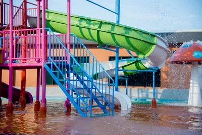 Colourful plastic slides in water park in the sunlight