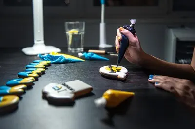 Preparation of handmade gingerbread with symbols of ukraine icing