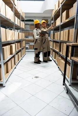 Multiethnic workers team tracking inventory using bar code systems