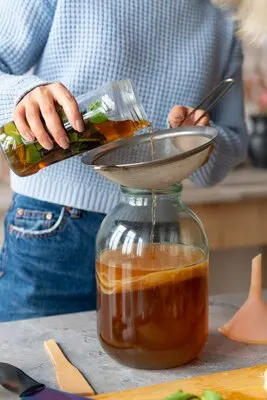 Front view woman preparing kombucha