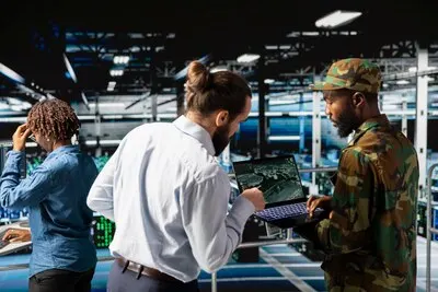 Army technicians use laptop to install server security systems in command center