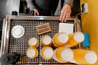 Top view of male barista at the professional coffee machine