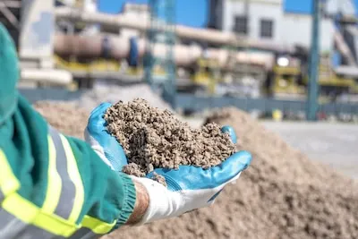 Person holding shredded paper used as an alternative fuel