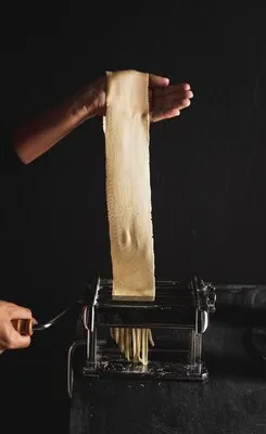 Close-up person with dough and dark background