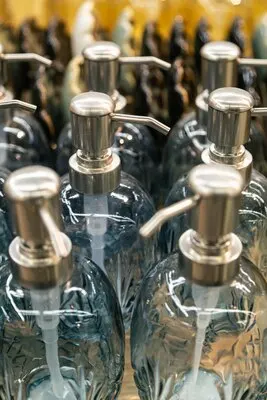 Containers for liquid soap or shampoo with a dispenser is sold in a supermarket
